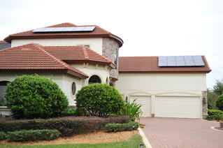 Residential Photovoltaic Solar Panels on two story home
