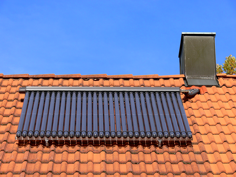 Evacuated Tube Solar Collector on Red Tile Roof