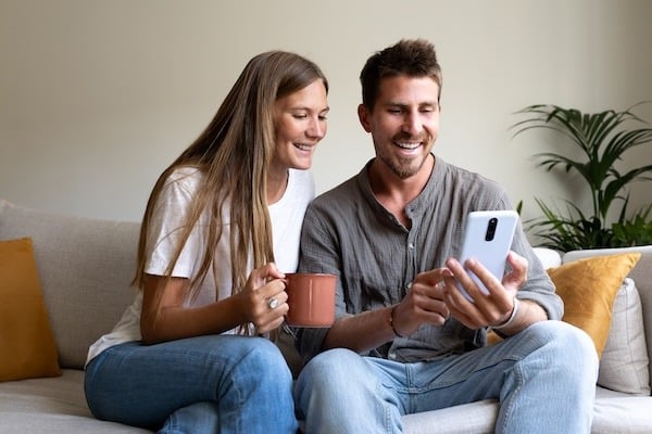 smiling-young-caucasian-couple-relaxing-at-home-us-2024-09-19-16-49-32-utc