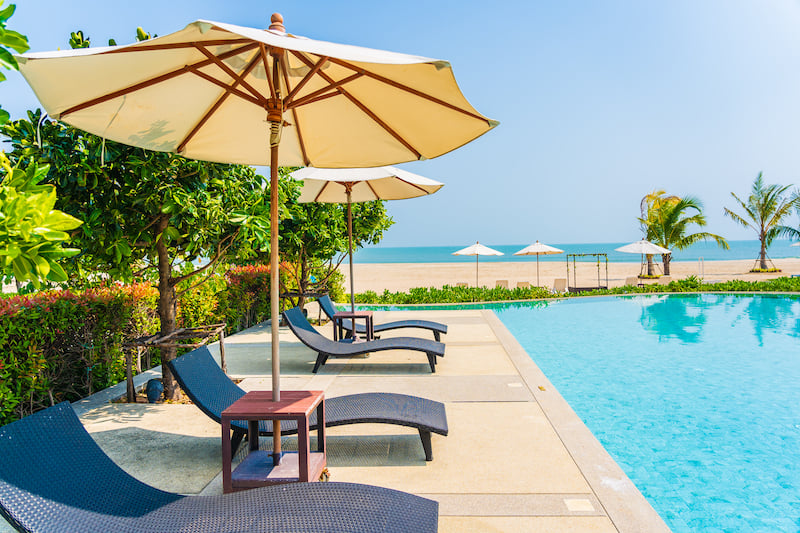 umbrella-and-chair-around-outdoor-swimming-pool-in-2022-12-16-03-56-31-utc