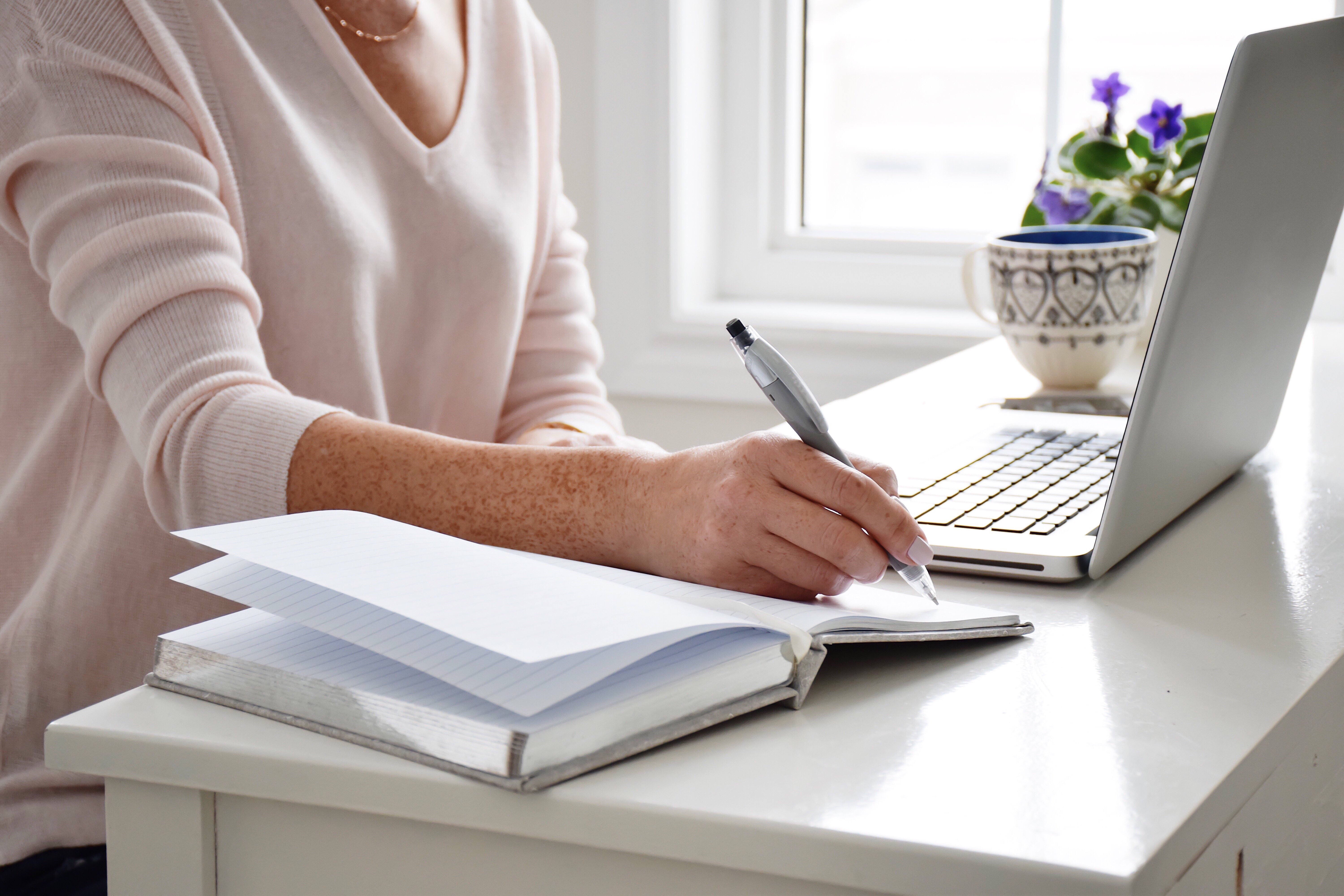 woman-sitting-at-a-desk-in-an-office-in-front-of-a-2022-11-14-05-56-17-utc